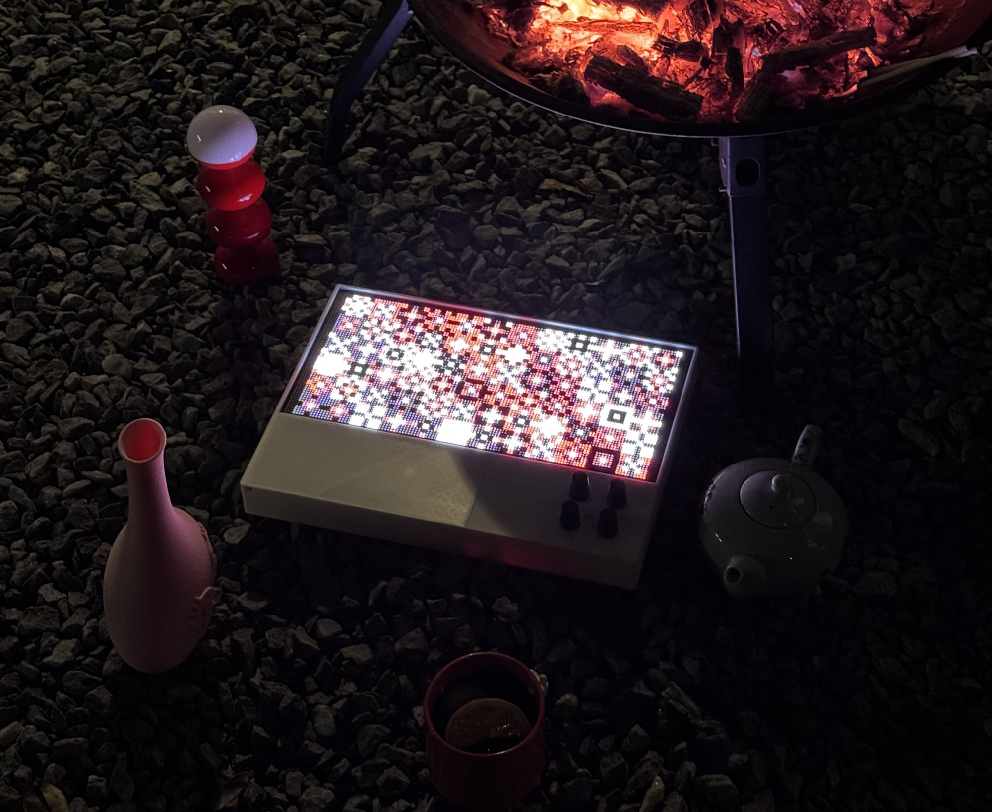 A Patternflow on gravel beside a campfire, among products from other brands